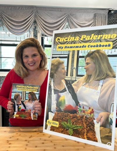 Rita-Prisco-holding-cookbook.jpg